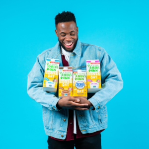 man holding oat milks